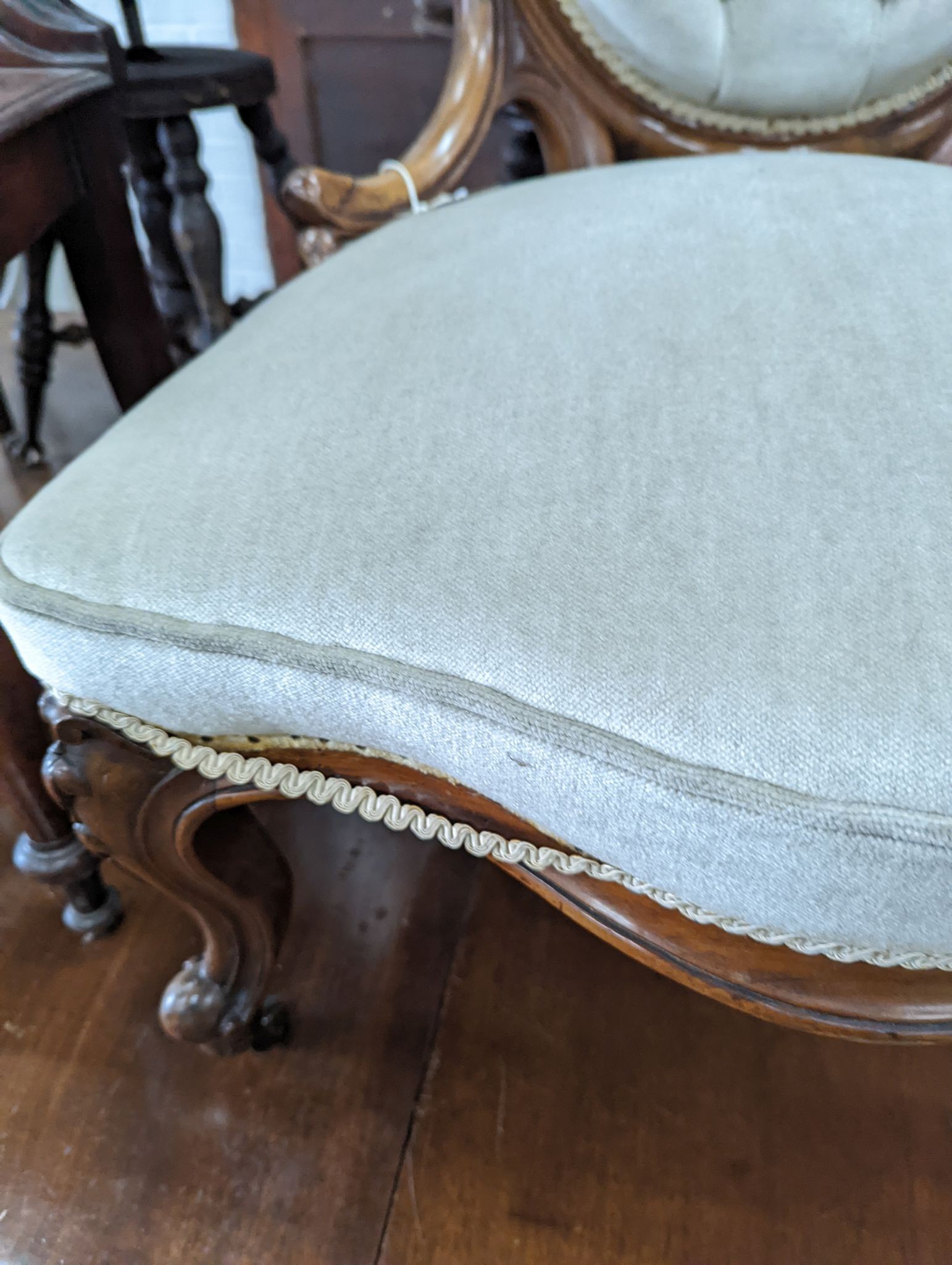 A Victorian walnut upholstered spoonback nursing chair